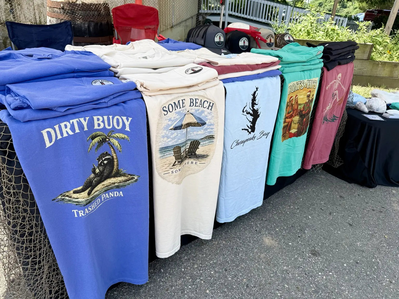 Dirty Buoy shirts and hats displayed at a local market
